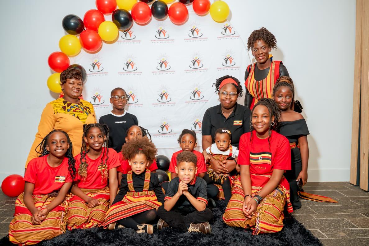 Children and adults posing together at the UCANI photo wall